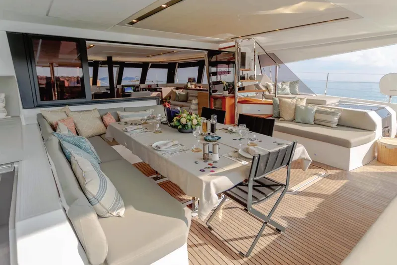  Yacht Photos Pics Luxurious 2021 Fountaine Pajot Samana 59 yacht interior with elegant dining setup.