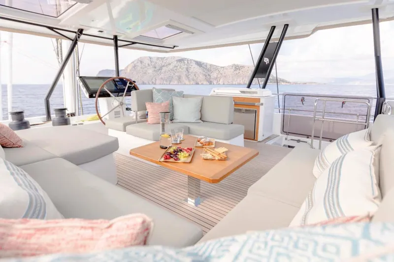  Yacht Photos Pics Luxurious 2021 Fountaine Pajot Samana 59 yacht interior with elegant seating and ocean view.