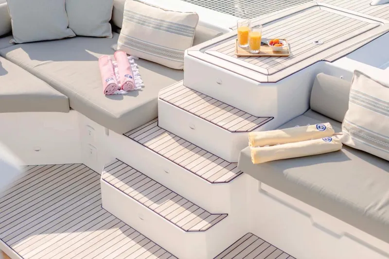  Yacht Photos Pics Luxurious deck seating on 2021 Fountaine Pajot Samana 59 yacht with refreshments and towels.