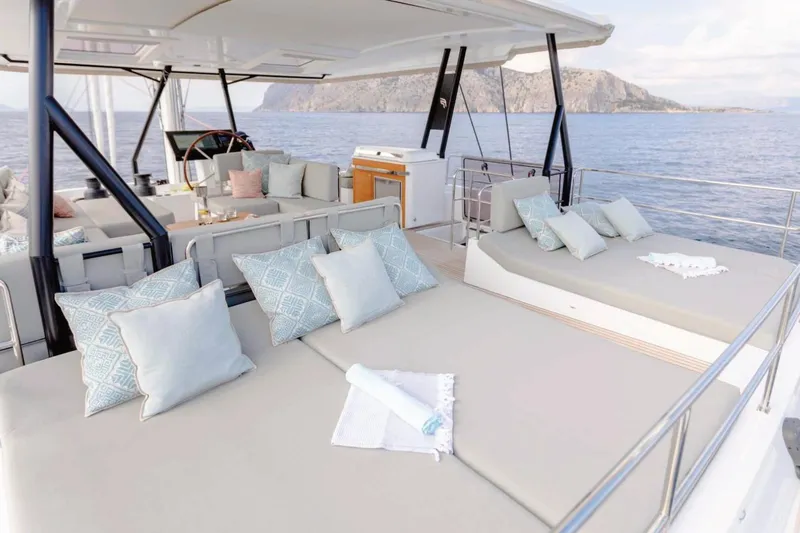  Yacht Photos Pics Luxurious 2021 Fountaine Pajot Samana 59 yacht with elegant outdoor seating and scenic ocean view.