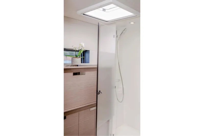  Yacht Photos Pics Modern bathroom interior of 2021 Fountaine Pajot Samana 59 yacht, featuring sleek design and skylight.