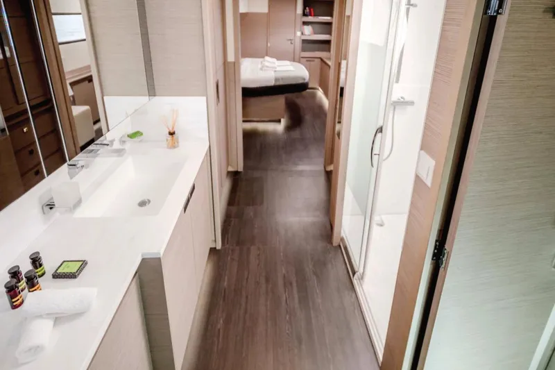  Yacht Photos Pics Luxurious interior of 2021 Fountaine Pajot Samana 59 yacht, featuring modern bathroom and bedroom.