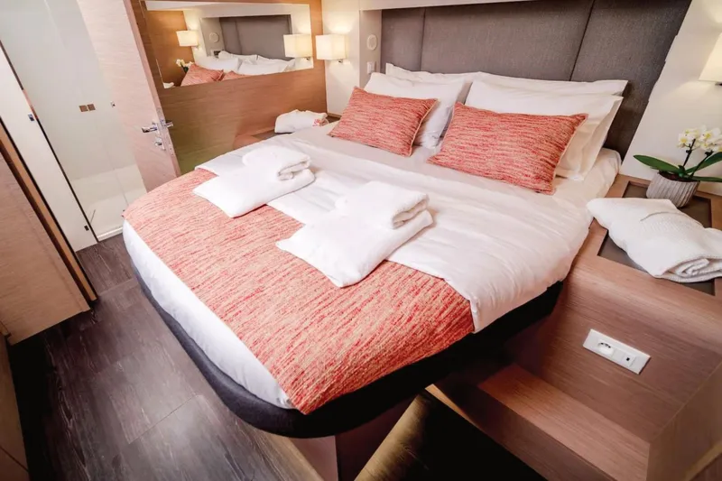  Yacht Photos Pics Luxurious bedroom interior on 2021 Fountaine Pajot Samana 59 yacht, featuring elegant bedding and decor.