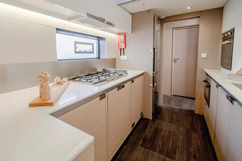  Yacht Photos Pics Modern kitchen interior of 2021 Fountaine Pajot Samana 59 yacht, featuring sleek design and appliances.
