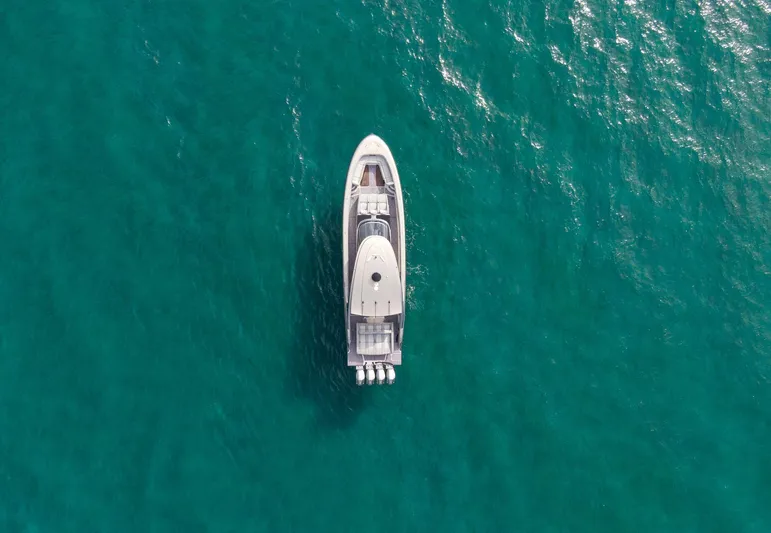  Yacht Photos Pics Aerial view of 2024 Mystic Powerboats M5200 on turquoise water.