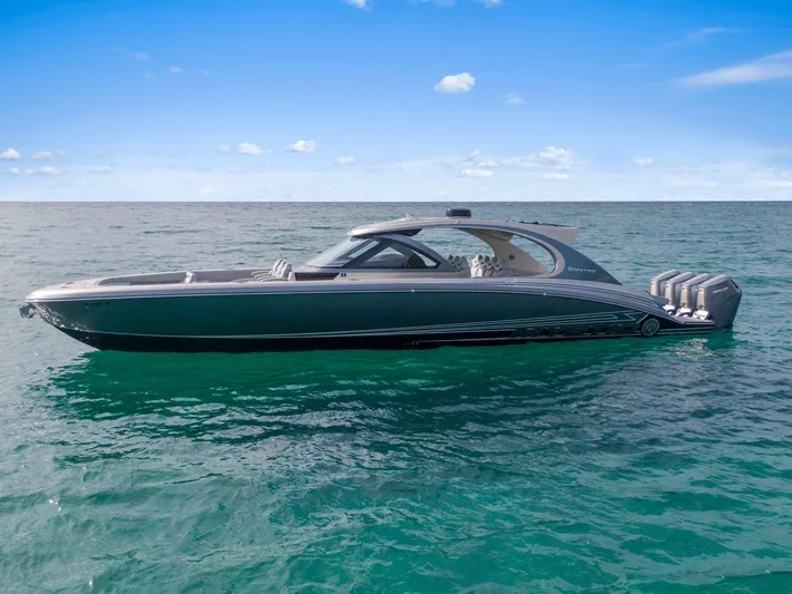  Yacht Photos Pics 2024 Mystic Powerboats M5200 luxury boat on open water under clear blue sky.