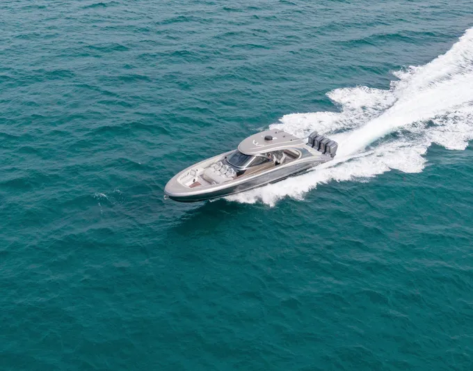  Yacht Photos Pics 2024 Mystic Powerboats M5200 cruising on open water, showcasing sleek design and powerful engines.