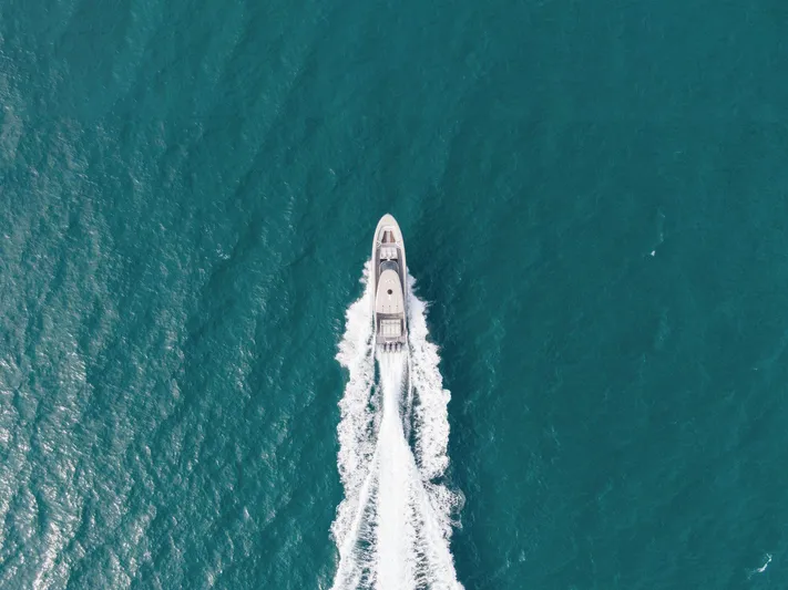  Yacht Photos Pics Aerial view of 2024 Mystic Powerboats M5200 cruising on open water.