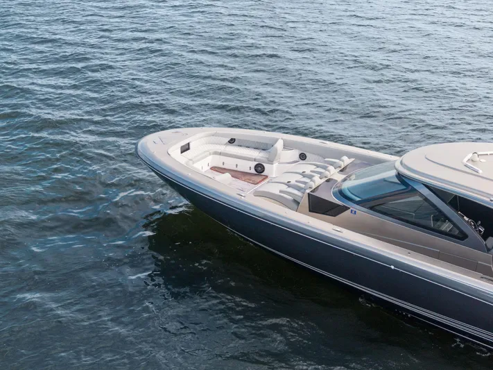  Yacht Photos Pics 2024 Mystic Powerboats M5200 cruising on open water, showcasing sleek design and luxury features.