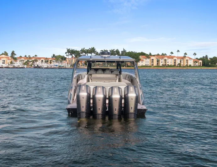  Yacht Photos Pics 2024 Mystic Powerboats M5200 on water, showcasing powerful engines and sleek design.