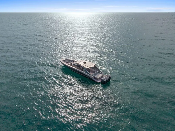  Yacht Photos Pics 2024 Mystic Powerboats M5200 cruising on open water under clear skies.