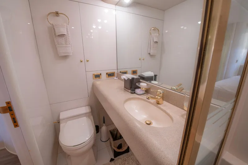 Sea Journey Yacht Photos Pics Luxurious bathroom in a 1997 Lazzara 76 Motor Yacht with elegant fixtures and ample storage.