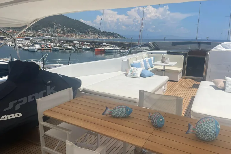  Yacht Photos Pics Luxurious 2009 Castagnola 24 yacht deck with seating, table, and marina view.