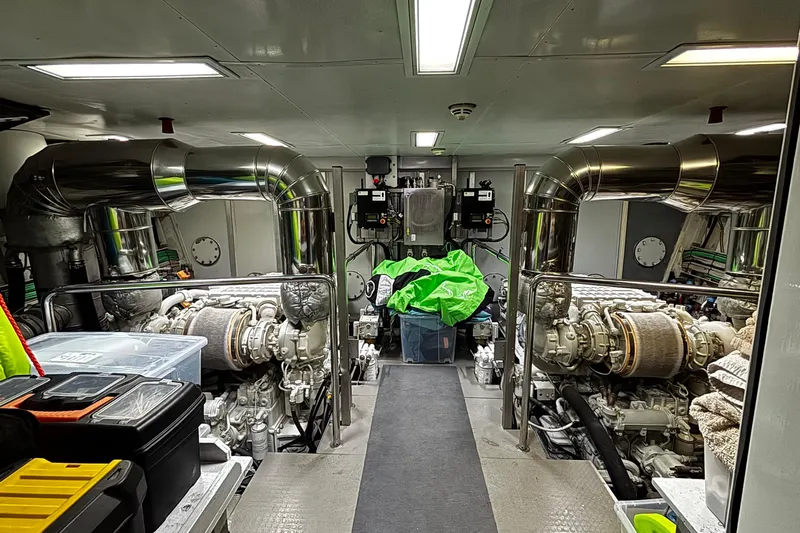  Yacht Photos Pics Engine room of a 2009 Castagnola 24 yacht, featuring dual engines and storage containers.