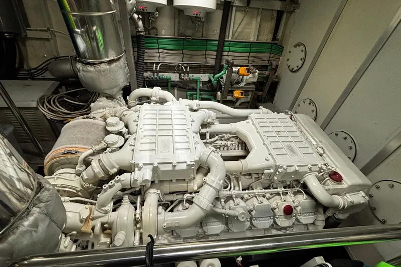  Yacht Photos Pics Engine room of a 2009 Castagnola 24 yacht, showcasing complex machinery and piping.
