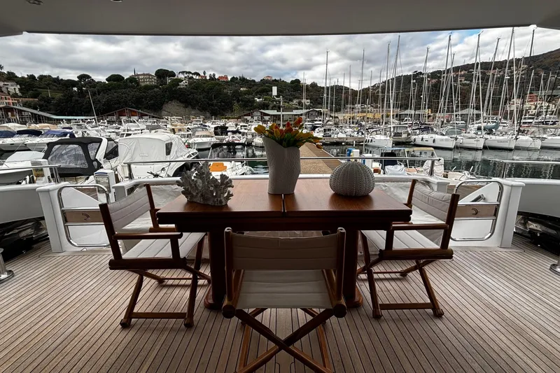  Yacht Photos Pics Luxury yacht deck with dining table, chairs, and marina view; Castagnola 24, 2009 model.