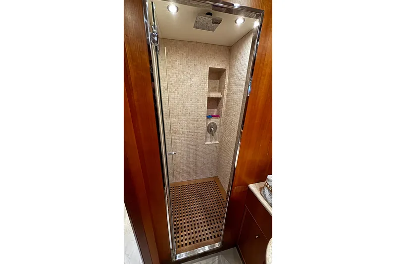  Yacht Photos Pics Luxurious shower in 2009 Castagnola 24 yacht with wooden accents and modern fixtures.