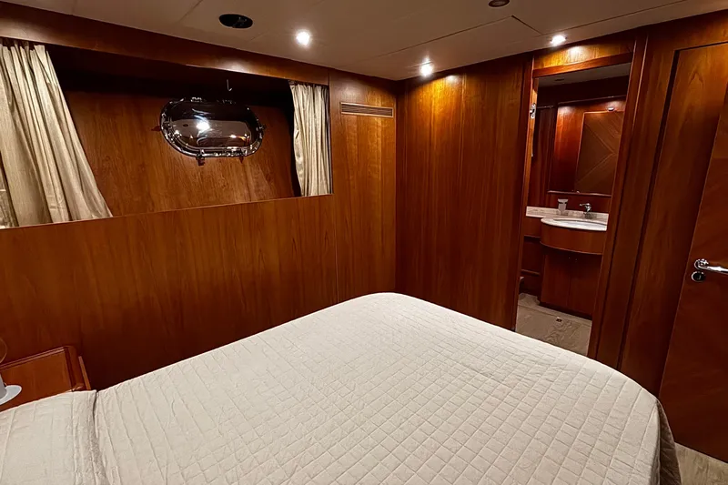  Yacht Photos Pics Luxurious wooden interior of 2009 Castagnola 24 yacht cabin with bed and ensuite bathroom.
