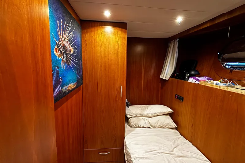  Yacht Photos Pics Cozy cabin interior of 2009 Castagnola 24 yacht with wooden paneling and marine artwork.