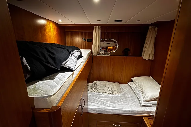  Yacht Photos Pics Cozy cabin interior of 2009 Castagnola 24 yacht with wooden bunk beds.