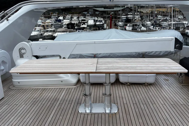 Yacht Photos Pics Luxury yacht deck with wooden table, Castagnola 24, 2009 model, marina background.