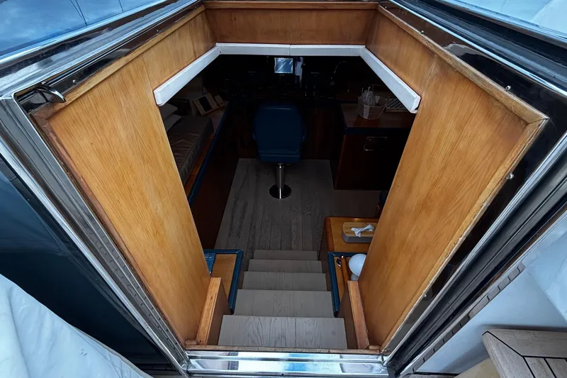  Yacht Photos Pics Interior view of 2009 Castagnola 24 yacht, featuring wooden stairs and seating area.