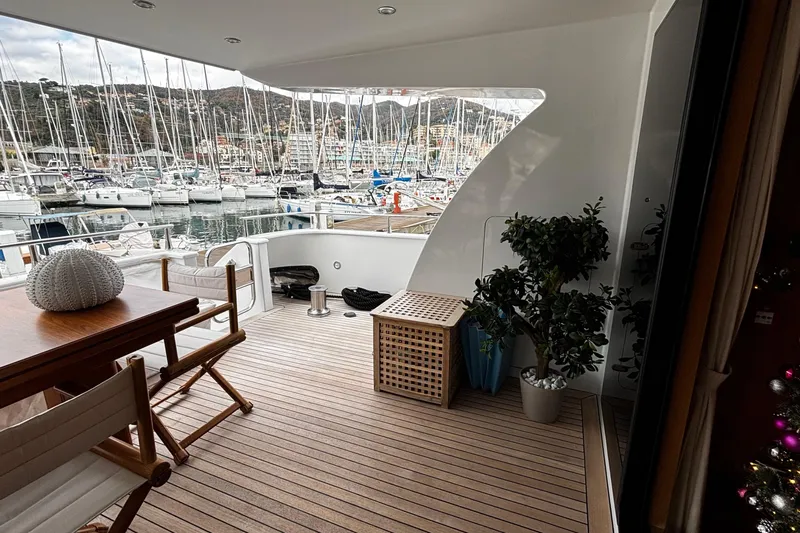  Yacht Photos Pics Luxurious 2009 Castagnola 24 yacht deck with wooden flooring and marina view.