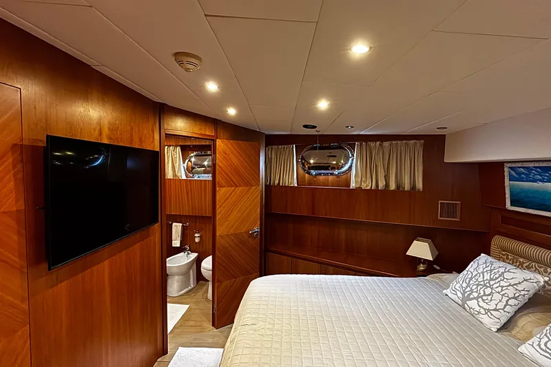  Yacht Photos Pics Luxurious 2009 Castagnola 24 yacht bedroom with wood paneling and modern amenities.