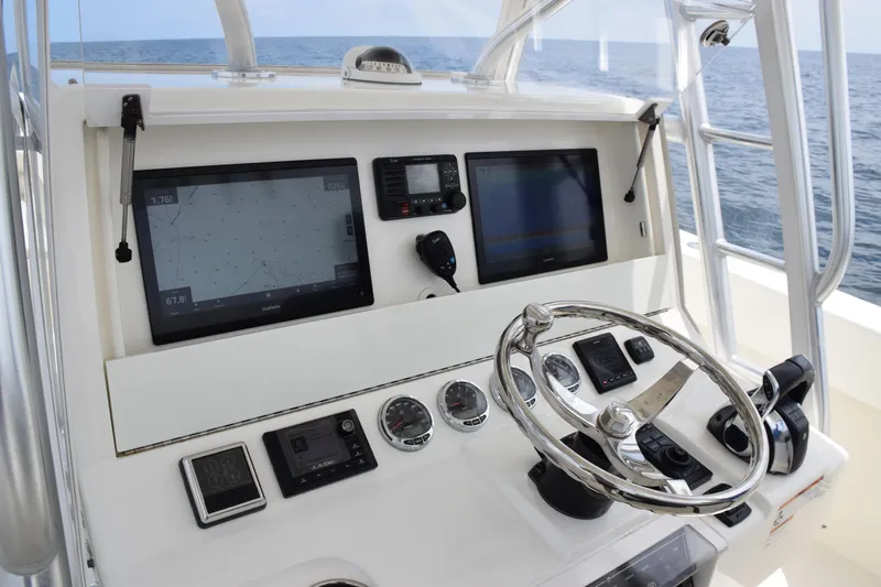 Yacht Photos Pics 2020 SeaVee 370z helm with navigation screens and steering wheel, ocean view.