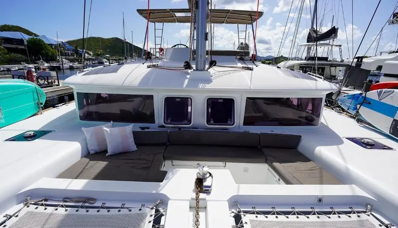 Great Adventure Yacht Photos Pics 2014 Lagoon 450 catamaran with spacious deck and comfortable seating in a marina.