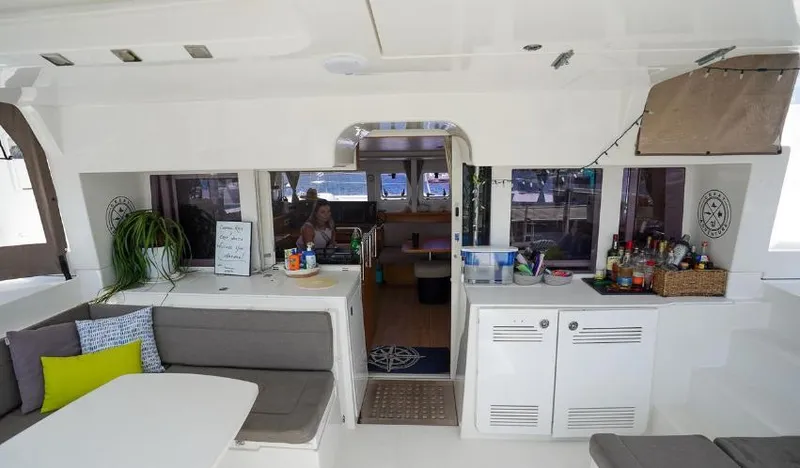 Great Adventure Yacht Photos Pics Interior of 2014 Lagoon 450 catamaran with seating, table, and kitchenette.