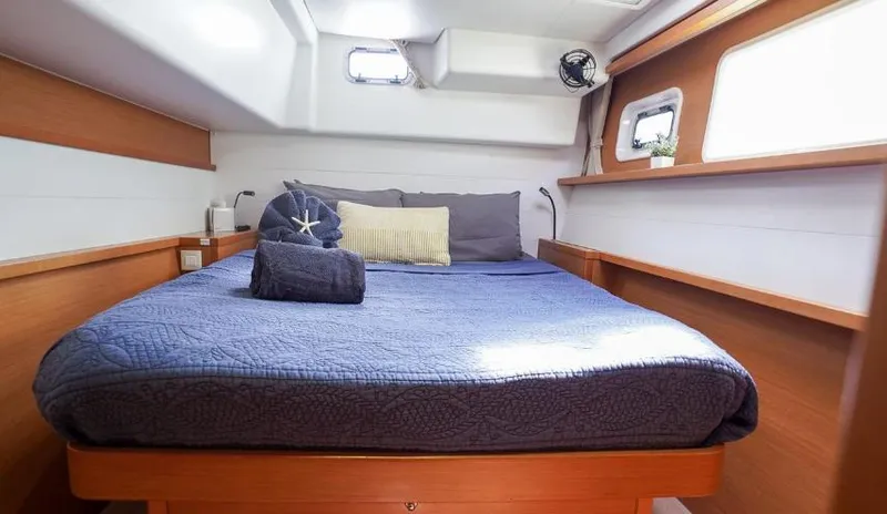 Great Adventure Yacht Photos Pics Cozy cabin interior of 2014 Lagoon 450 catamaran with a neatly made bed.