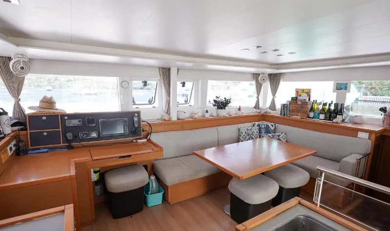 Great Adventure Yacht Photos Pics Interior of 2014 Lagoon 450 catamaran with cozy seating, dining table, and navigation equipment.