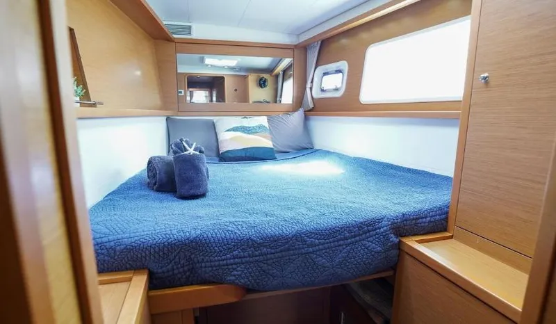 Great Adventure Yacht Photos Pics Cozy cabin interior of 2014 Lagoon 450 catamaran with blue bedding and wooden accents.