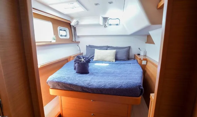 Great Adventure Yacht Photos Pics Cozy cabin interior of 2014 Lagoon 450 catamaran with a neatly made bed.