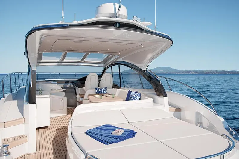  Yacht Photos Pics 2021 Princess V50 Open yacht with luxurious deck and seating, cruising on a clear blue sea.
