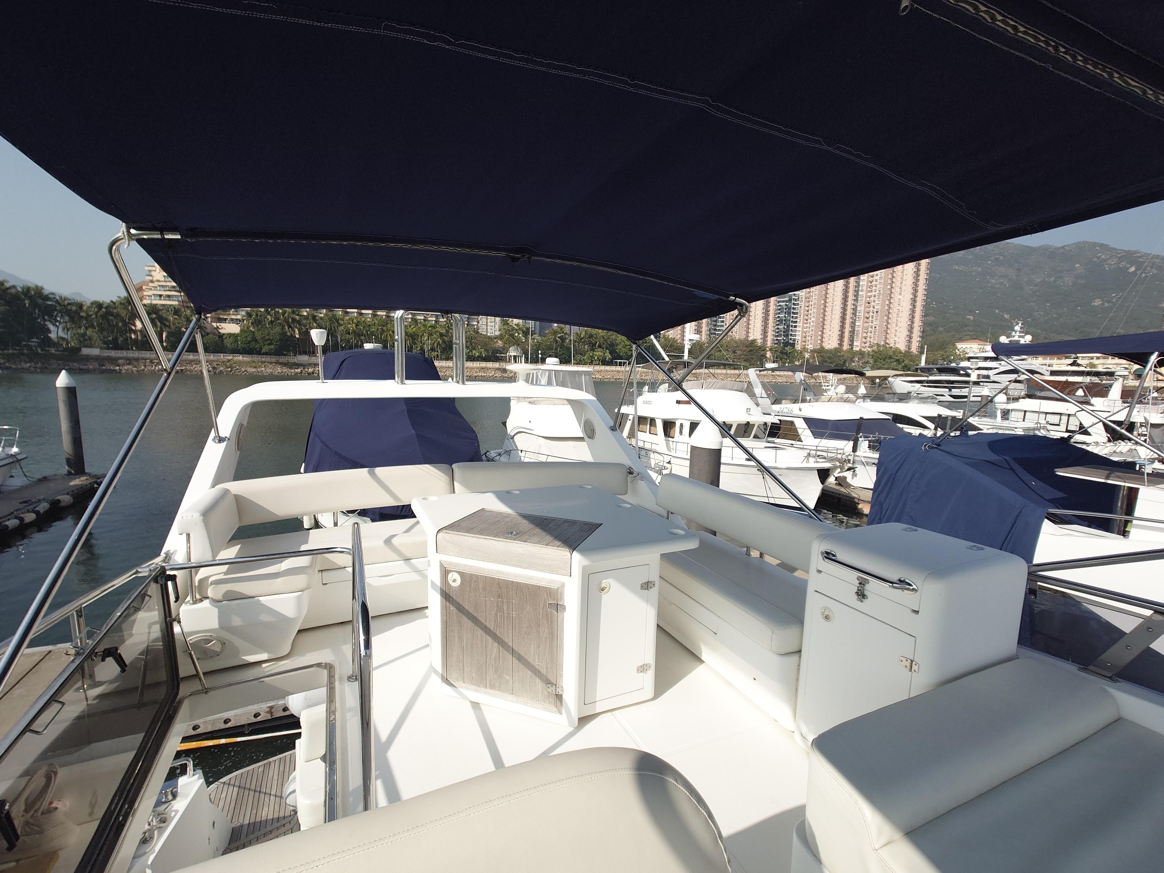 Luxurious Ruby 52 yacht deck with seating, canopy, and marina view, 2009 model.