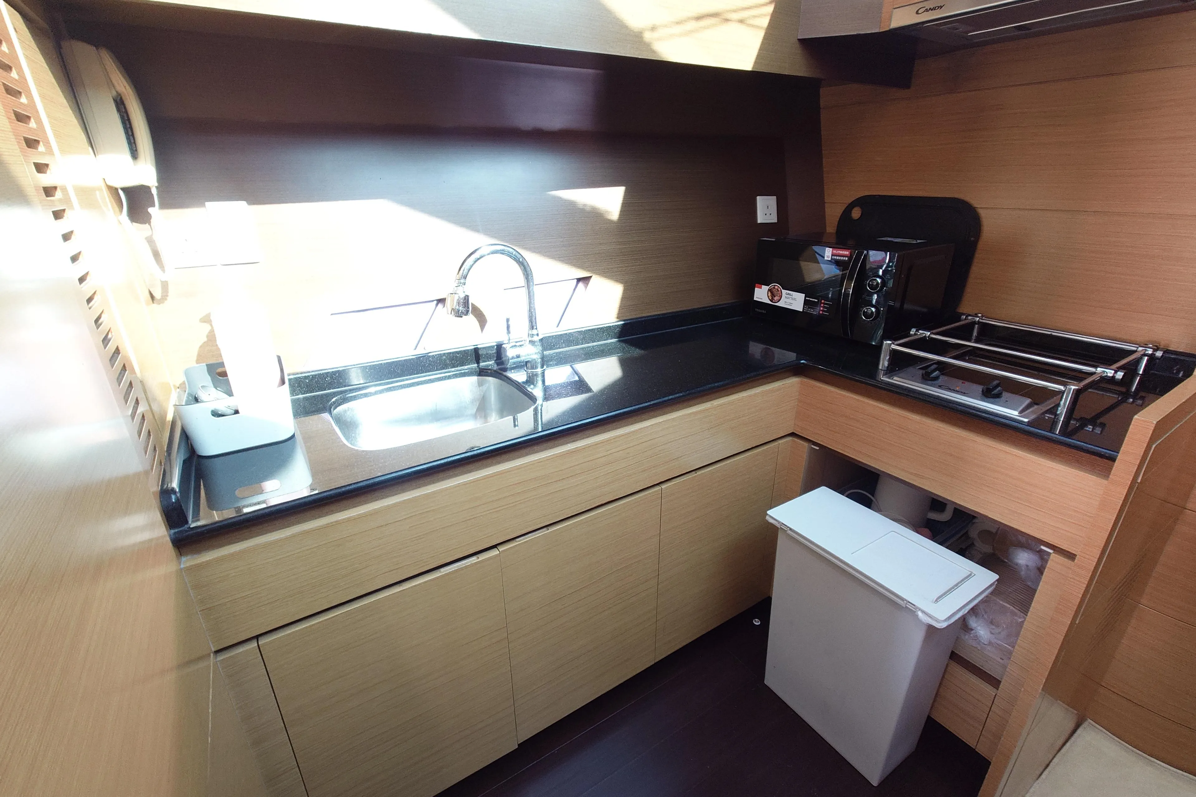 Modern kitchen in Ruby 52 yacht, 2009 model, featuring sleek countertops and built-in appliances.