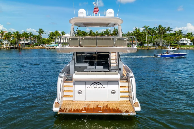  Yacht Photos Pics Azimut Fly 72 yacht, 2021 model, cruising on a sunny day with palm trees in the background.