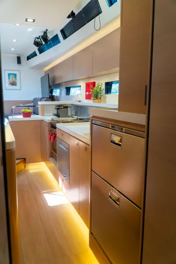  Yacht Photos Pics Modern kitchen interior on 2018 Amel 50 yacht, featuring sleek cabinetry and ambient lighting.