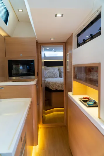  Yacht Photos Pics Luxurious interior of 2018 Amel 50 yacht with modern kitchen and cozy bedroom.