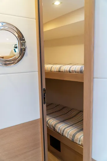  Yacht Photos Pics Interior of 2018 Amel 50 yacht with cozy bunk beds and porthole.
