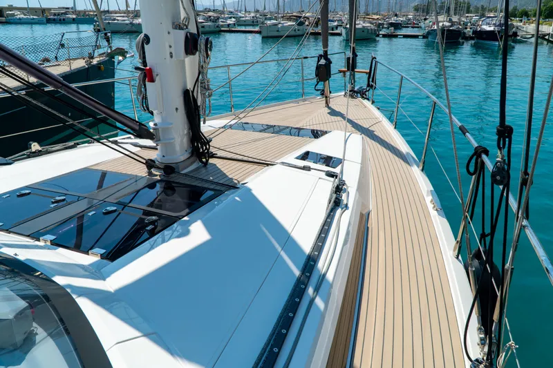  Yacht Photos Pics Sleek 2018 Amel 50 yacht deck with modern design, docked in a serene marina.