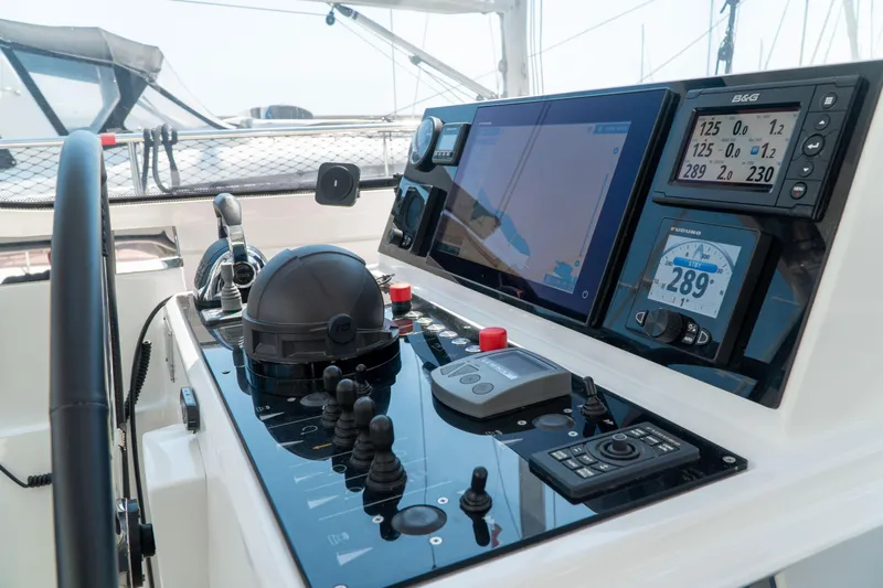  Yacht Photos Pics Control panel of a 2018 Amel 50 yacht with navigation instruments and steering wheel.