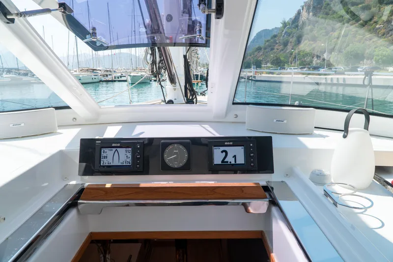  Yacht Photos Pics Cockpit view of 2018 Amel 50 yacht with navigation instruments and marina background.