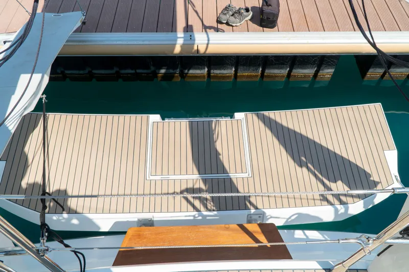  Yacht Photos Pics Deck of a 2018 Amel 50 yacht with teak flooring and marina view.