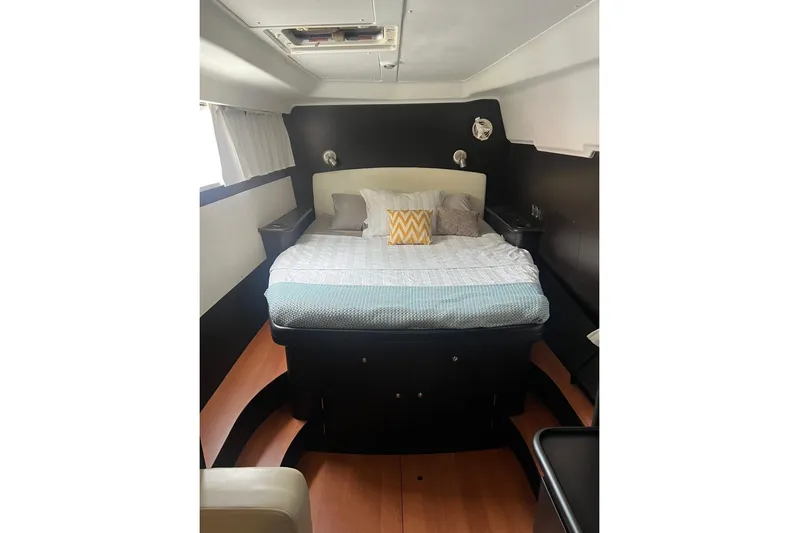 Queen Butterfly Yacht Photos Pics Interior cabin of 2006 Lagoon 440 yacht with cozy bed and modern decor.