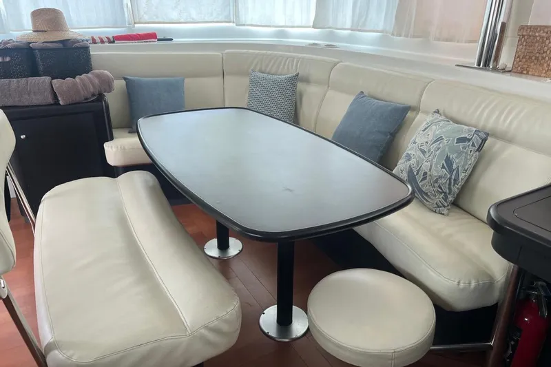 Queen Butterfly Yacht Photos Pics Interior of 2006 Lagoon 440 yacht with white leather seating and decorative pillows.