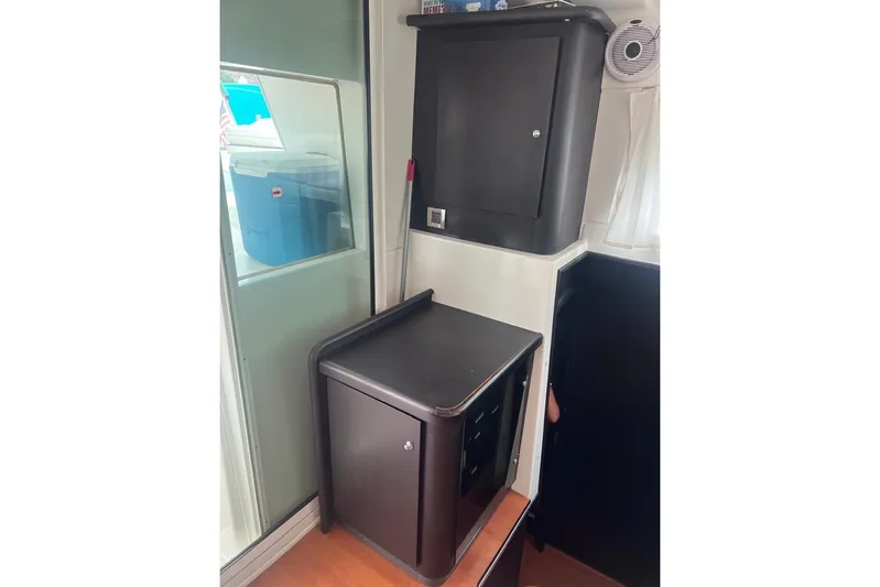 Queen Butterfly Yacht Photos Pics Interior of 2006 Lagoon 440 yacht with storage cabinets and window view.