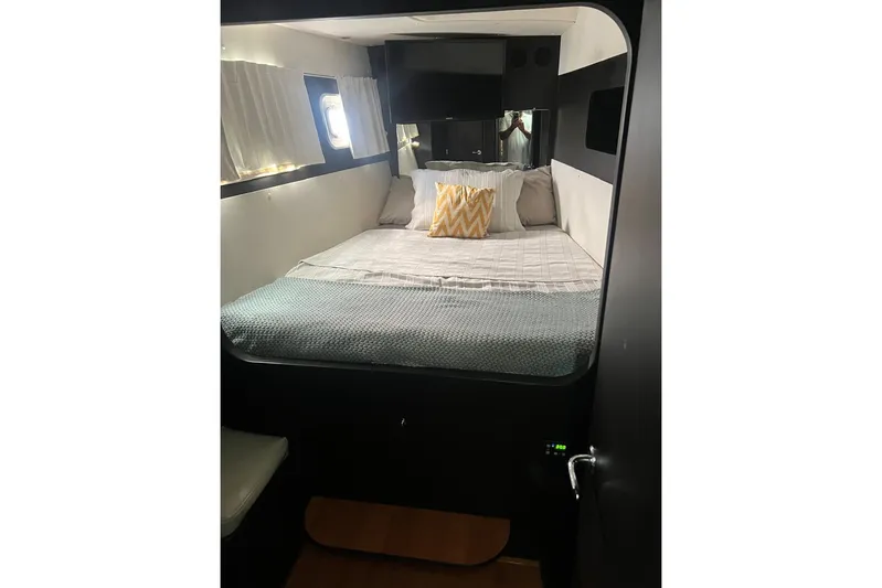 Queen Butterfly Yacht Photos Pics Cozy bedroom interior of 2006 Lagoon 440 catamaran with bed, pillows, and window.